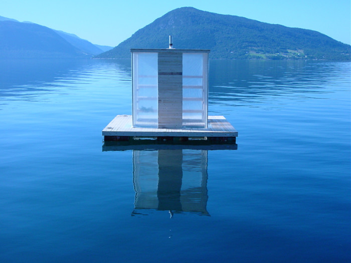 A small house floating in the water.