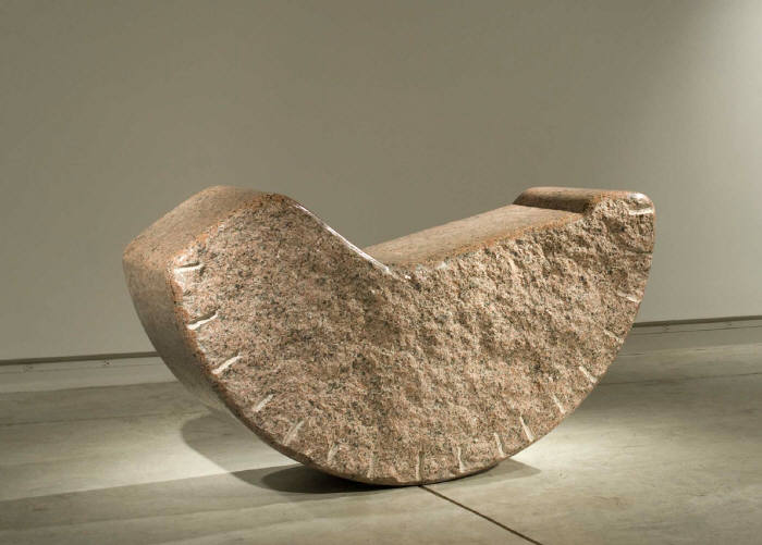 A large stone sculpture by Jesus Moroles in an empty room.