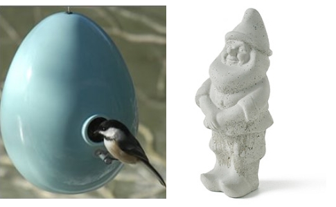 A bird feeder and a statue of a gnome.