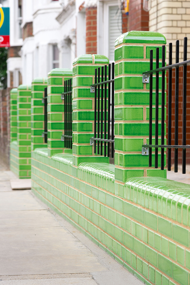Broughton Road garden fence with green french enameled lavastone bricks