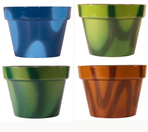 Four different colored flower pots on a white background.