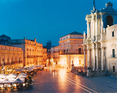 An old building in the middle of a square.