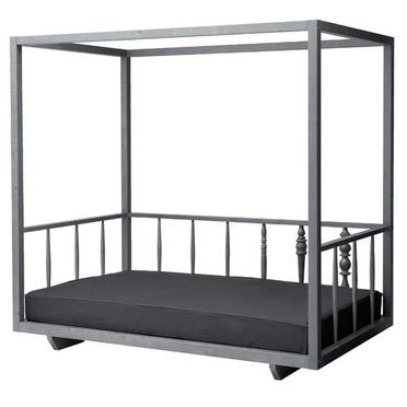 A metal canopy bed with a black mattress.
