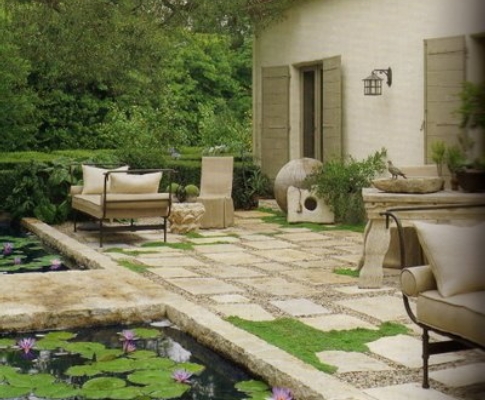 A backyard with a pond and lily pads.