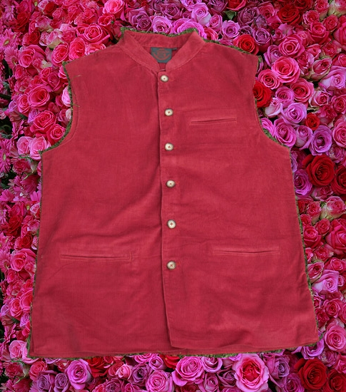A red nehru vest surrounded by roses.