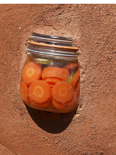 A jar with carrots in it.