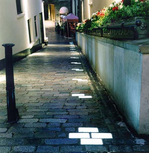 A street with a light shining down on it.