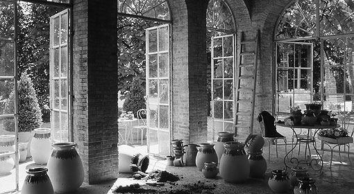 A black and white photo of a room full of vases.