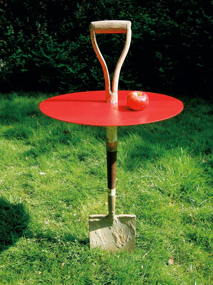 A red table with a shovel on it.