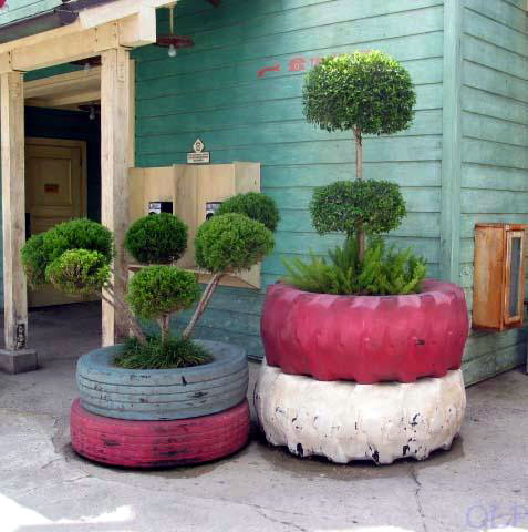 A tire planter in front of a building.