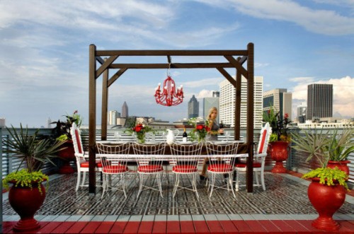 A deck with a table and chairs and a view of the city.