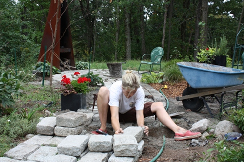 Rochelle Greayer building cobblestone patio