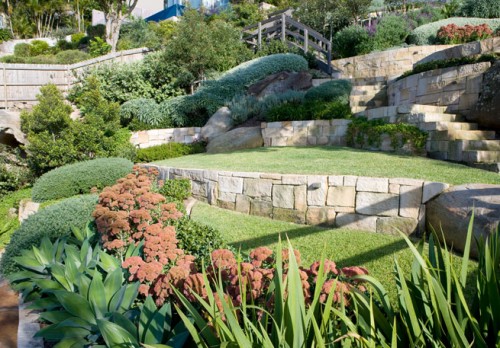 water side sloping garden by secret gardens of sydney