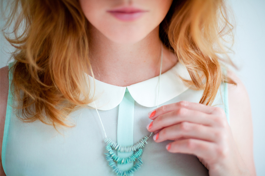 A woman wearing a turquoise necklace.