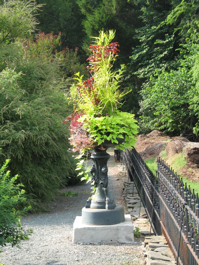 A large planter in the middle of a path.