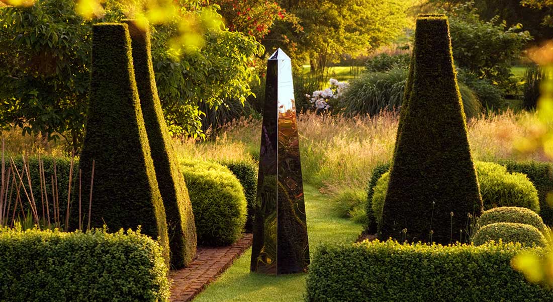 mirrored stainles steele obelisk by David Harbor Sundials seen in Pettifers Garden in Oxfordshire by clive nichols