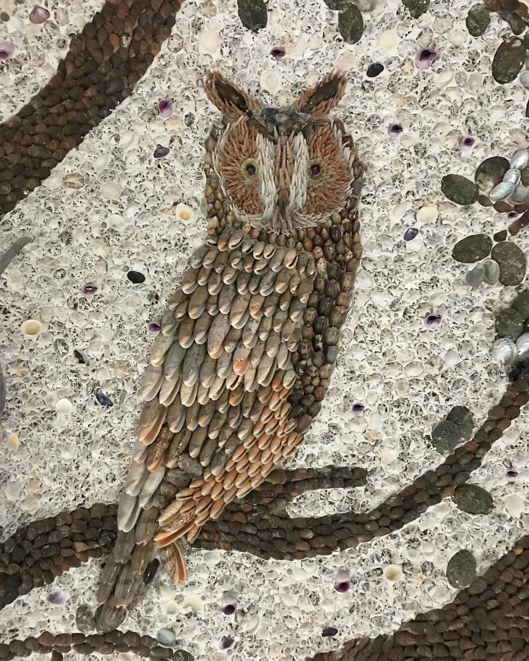 An owl sitting on a branch made of sea shells by blott kerr wilson