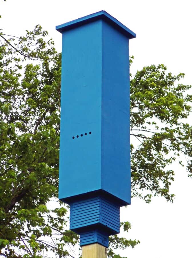 A blue box on top of a pole, designed specifically for bat houses.