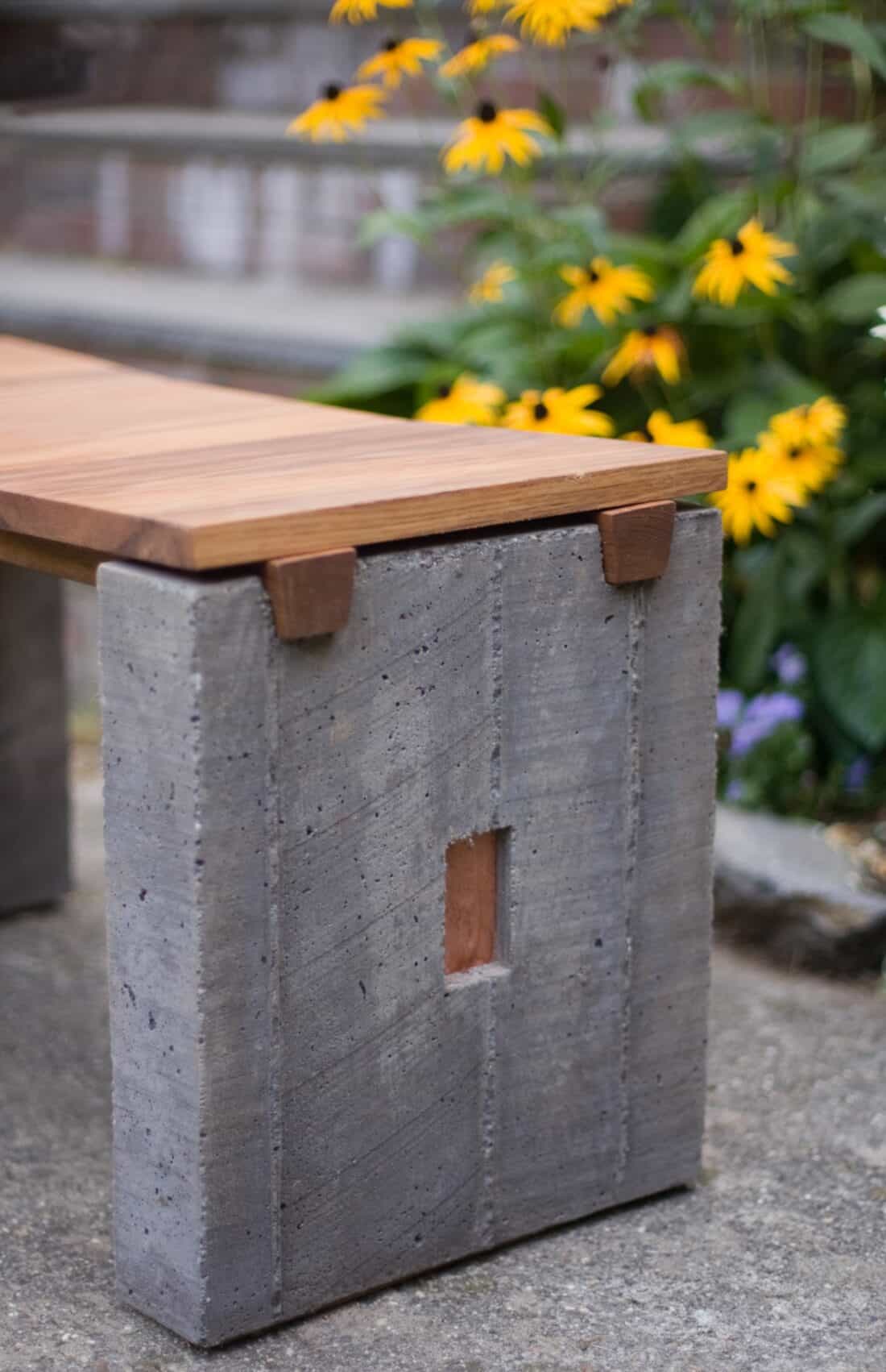 A bench made out of concrete and wood.