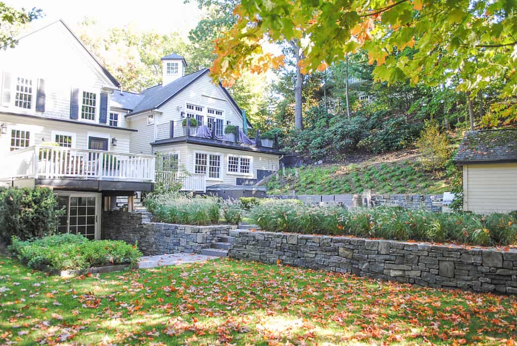 A home with a large yard and a stone walkway.