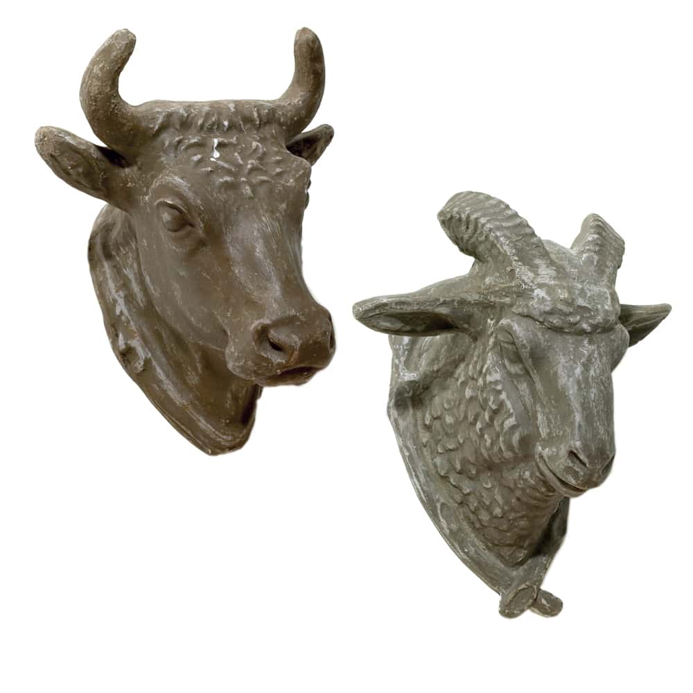 A pair of sculptures of a bull and a ram.