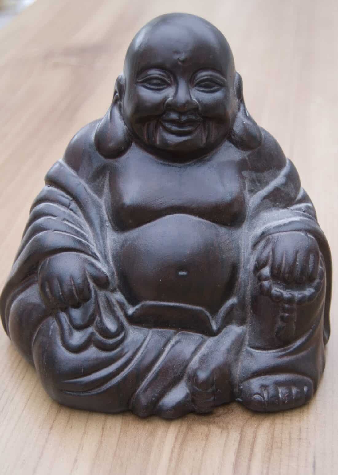 A statue of a smiling buddha.