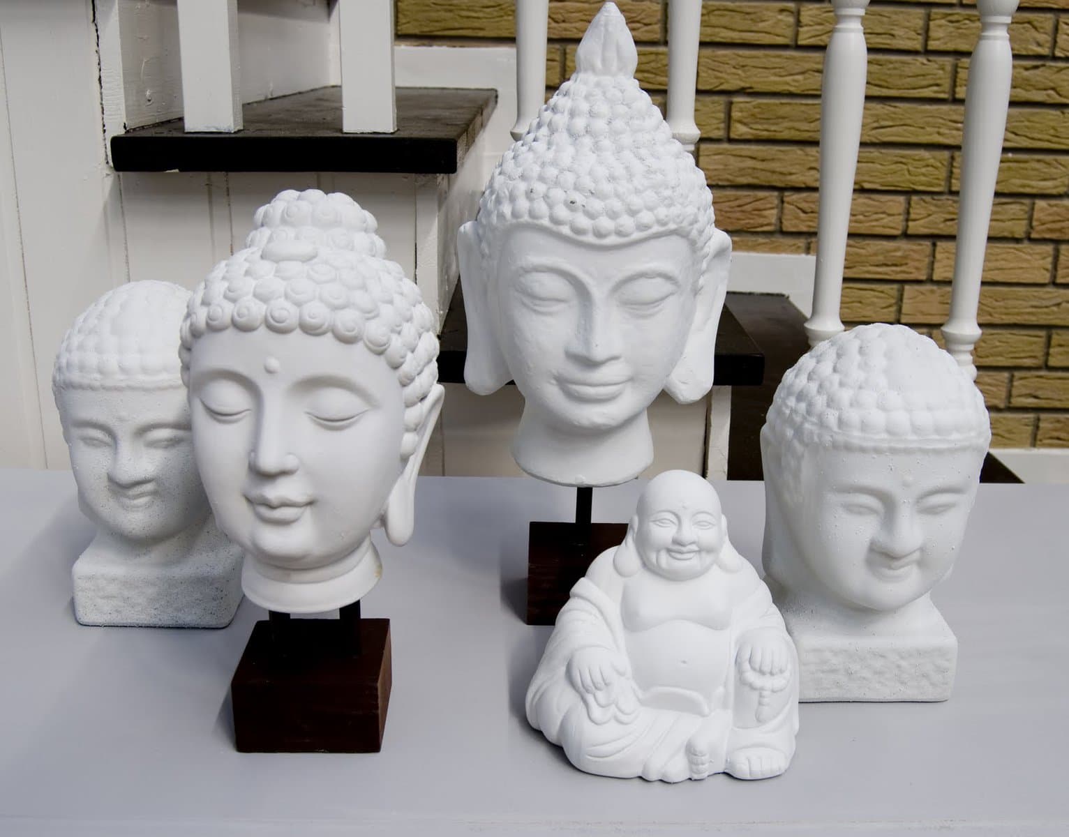A group of white garden budda statues.